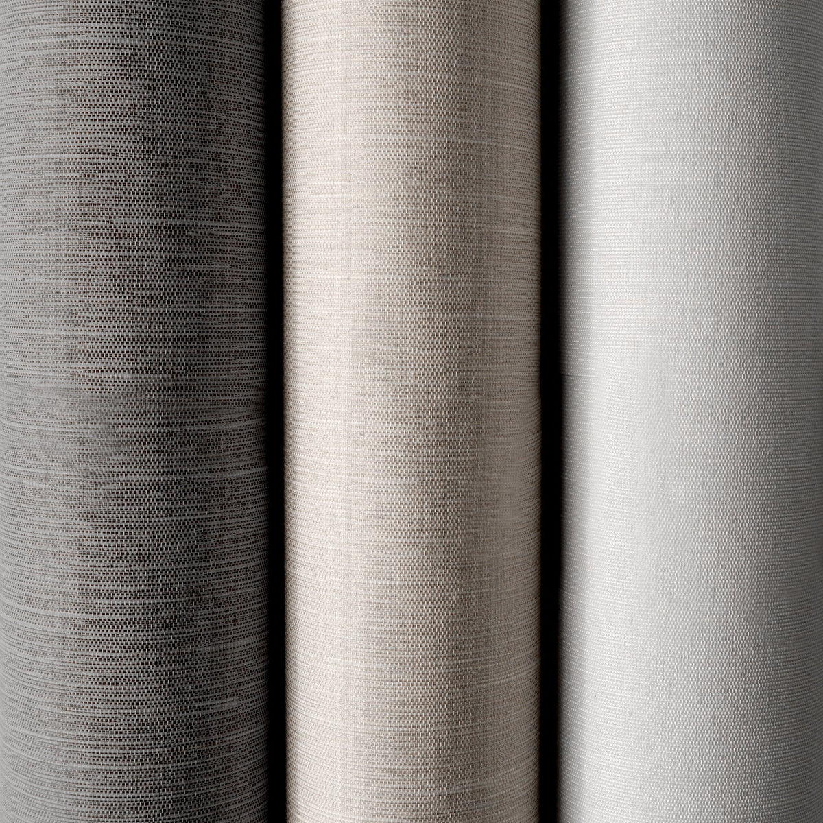Close-up of three different gray fabric swatches with varying textures.